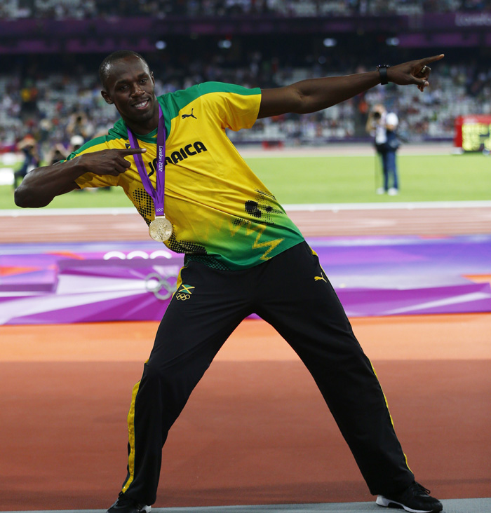 Jamacias Usain Bolt strikes his famous pose with his gold medal at the mens 200m victory ceremony during the london 2012 olympic games